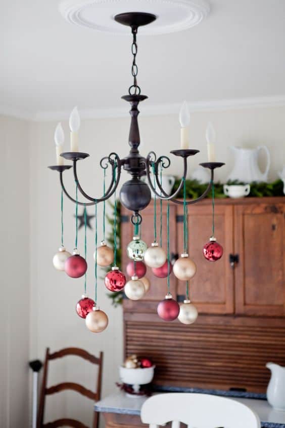 Easy DIY hanging ornament chandelier Christmas decor idea using dollar store ornaments and ribbon. Elegant Christmas decoration idea for mantle, window, ceiling, or wall. Great budget decor idea for the home, winter wedding, or Christmas party.