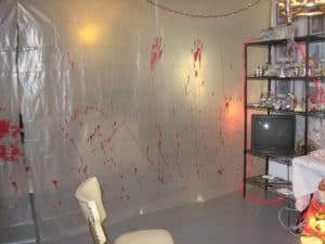 Easiest, best, and most creative Halloween party decorations that'll keep guests out using plastic sheets and acrylic paint.